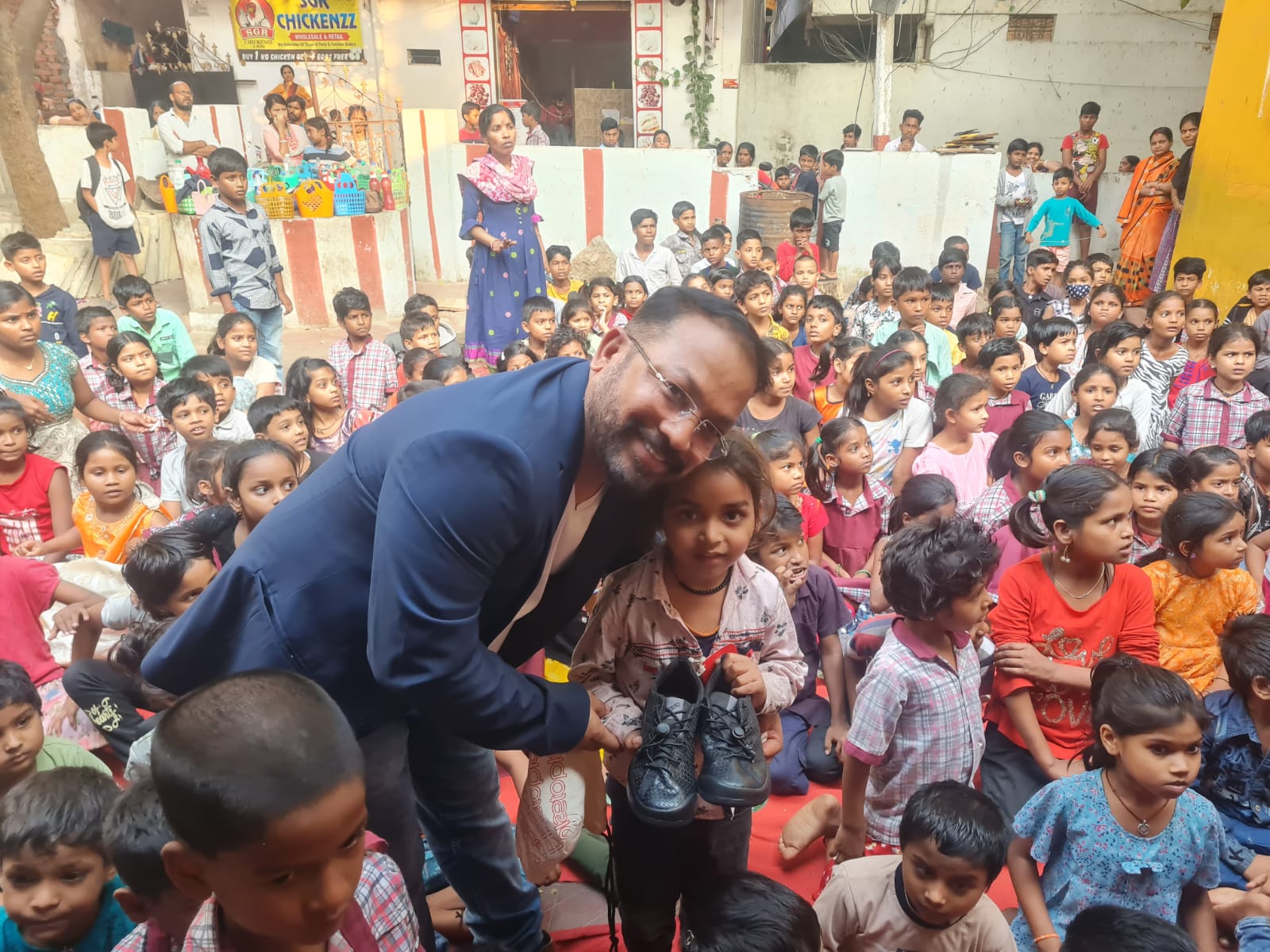 Durga Prasad Madasu with children at a community event